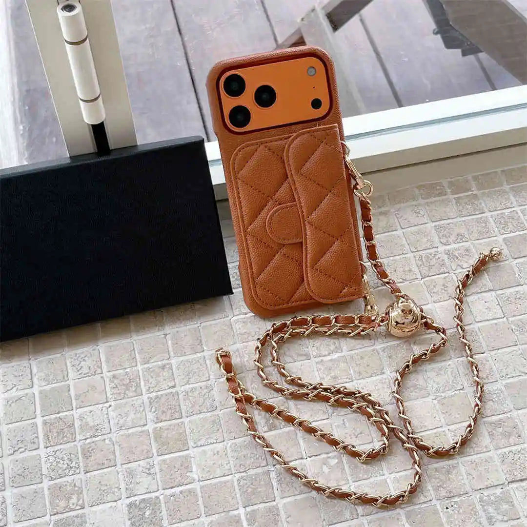 Brown quilted phone case with chain on a tiled floor