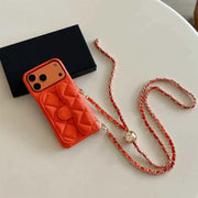 Orange quilted phone case with a chain on a white surface