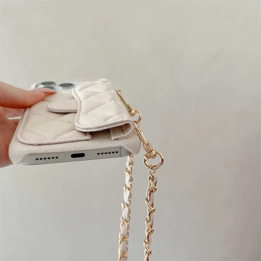 Phone case with chain strap held by a hand on a light background