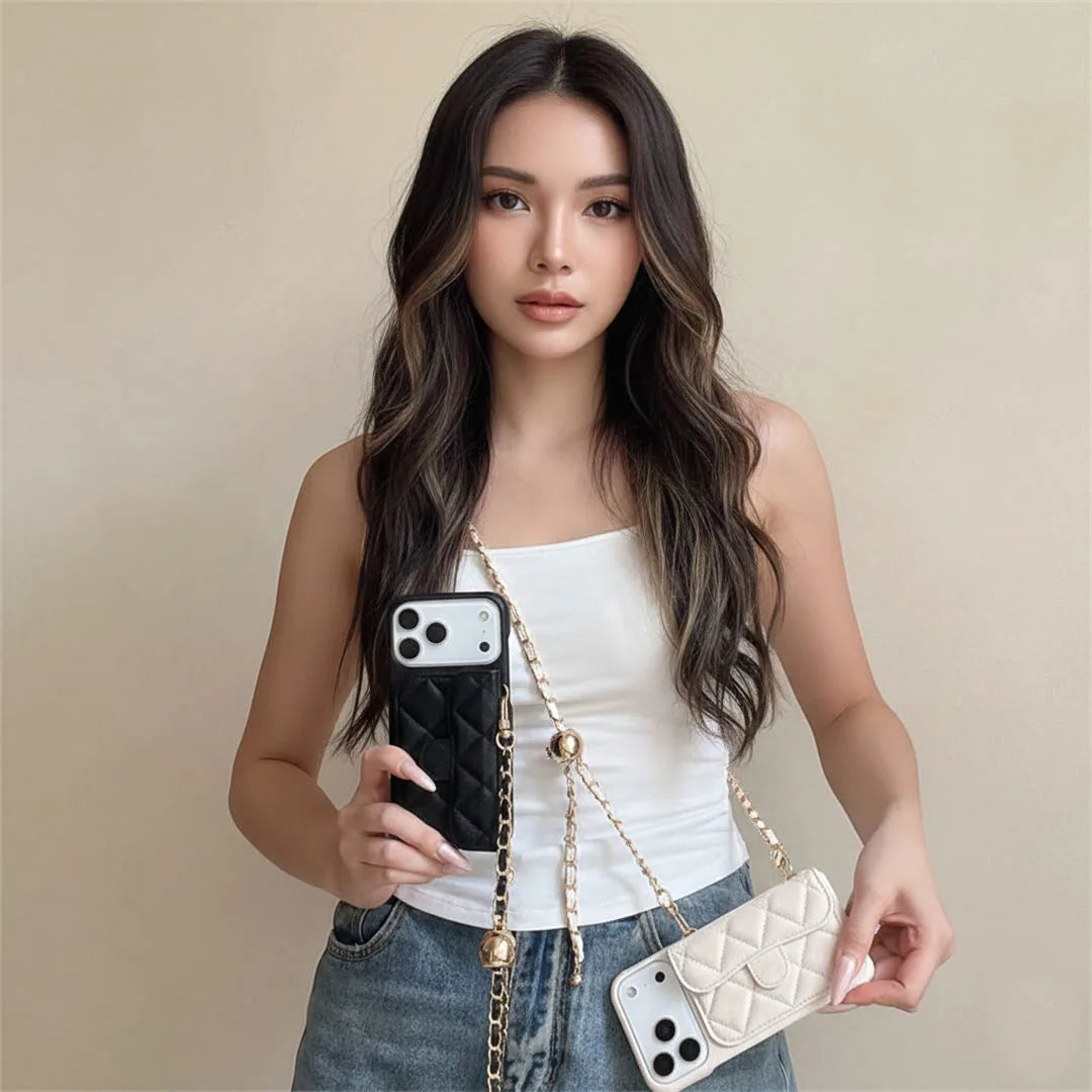 Woman holding two designer crossobdy phone cases, one black and one white, against a beige background