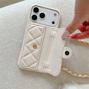 white quilted wallet phone case with a chain strap held by a hand on a light background