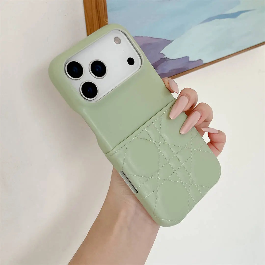 Hand holding a light green phone case with a subtle pattern against a neutral background