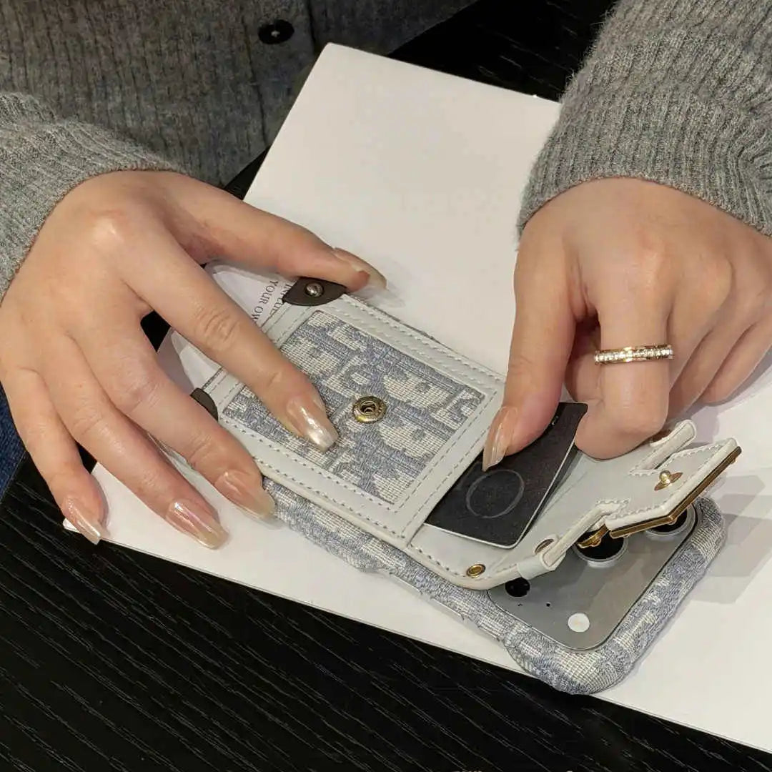 Person using a small electronic device on a white surface
