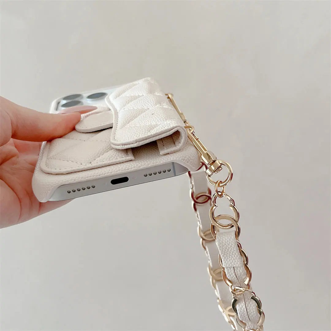 Phone case with chain strap held by a hand on a light gray background