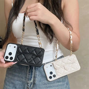 Person holding two phone cases with chain straps, one black and one white.