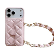 Pink quilted phone case with a chain strap on a white background