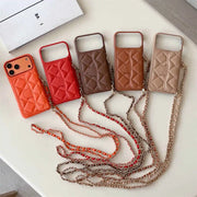 Five phone cases with chain straps in various colors on a white surface.