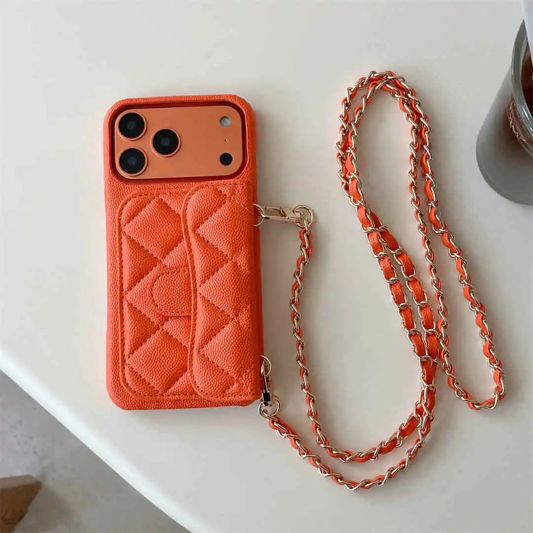 Orange quilted phone case with a matching chain on a white surface