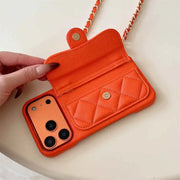 Orange quilted phone case with chain strap held by a hand on a light background