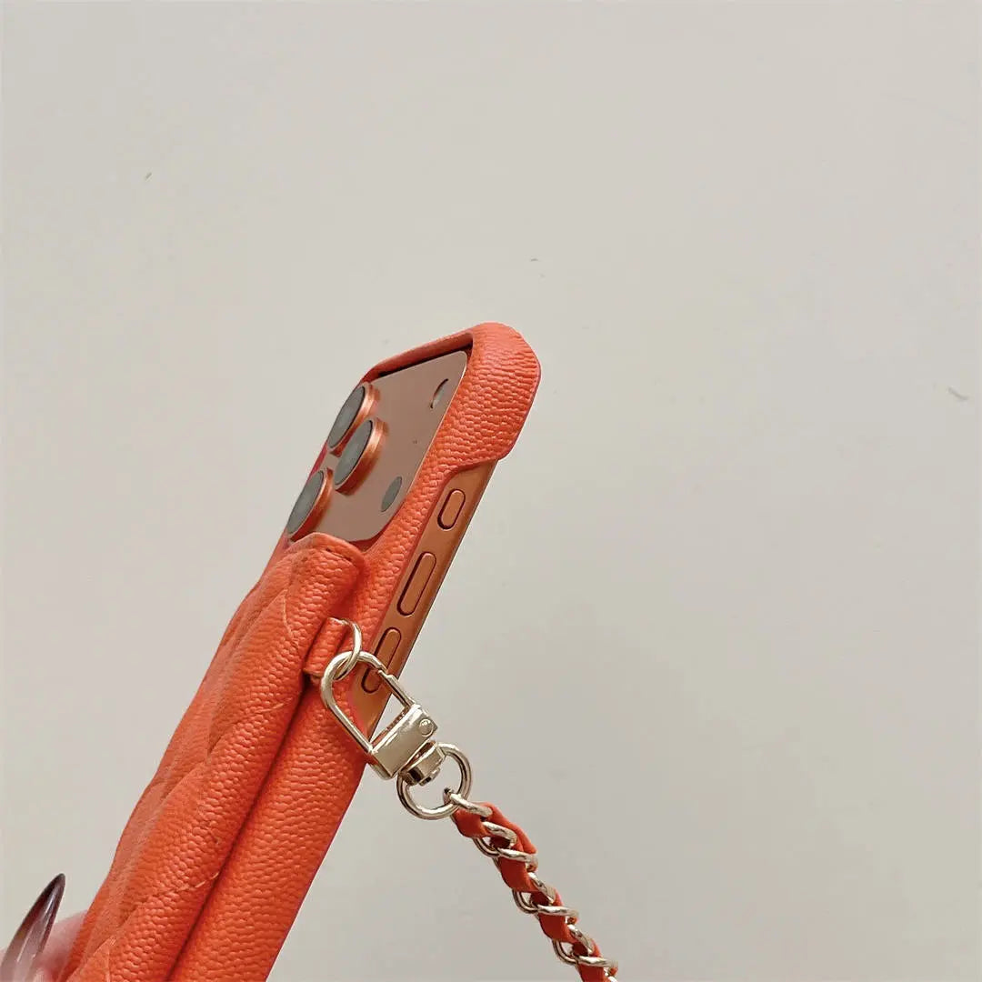 Orange phone case with a chain strap on a light gray background