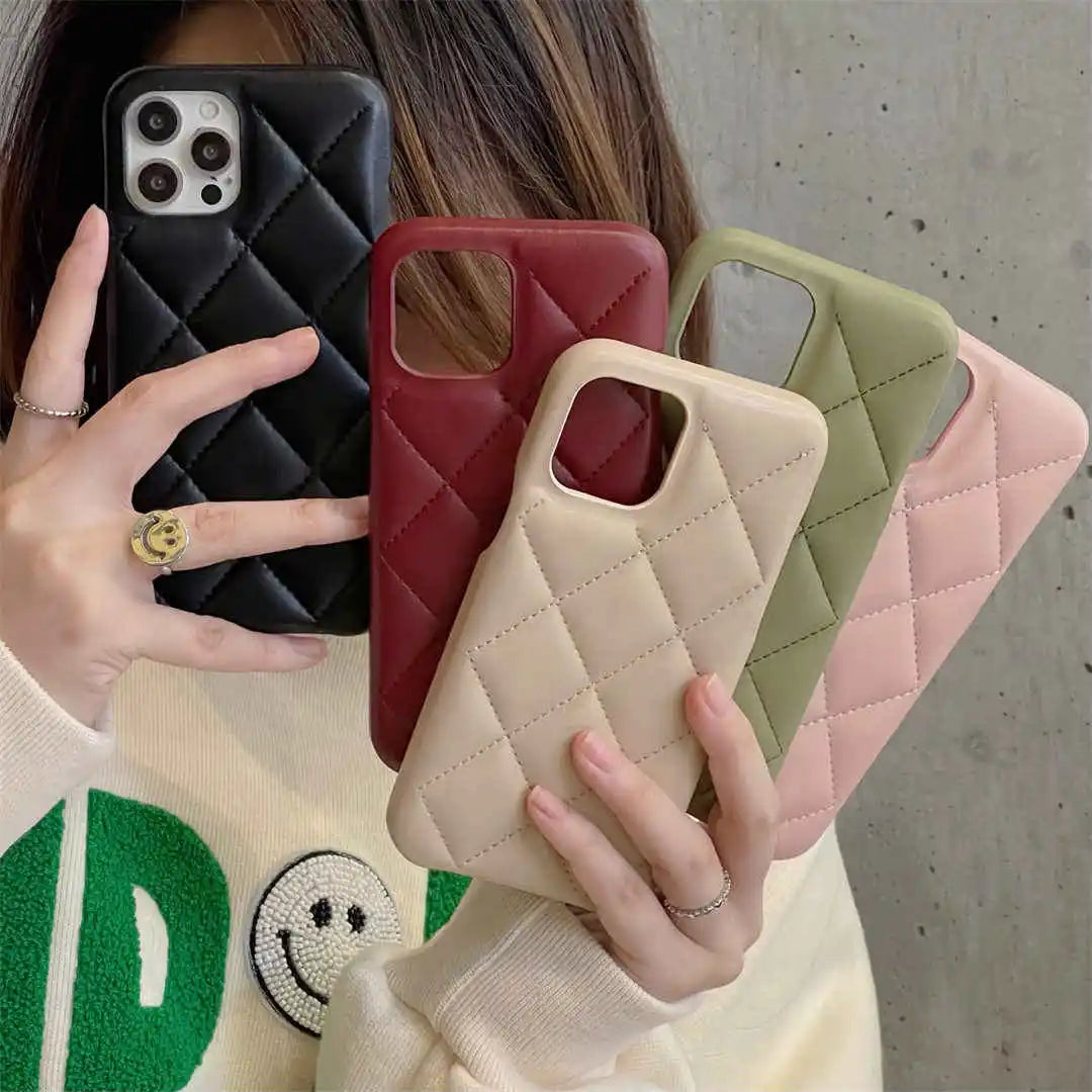 Person holding five quilted phone cases in black, red, beige, green, and pink.
