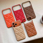 Five quilted phone cases with card slot in different colors on a textured surface.