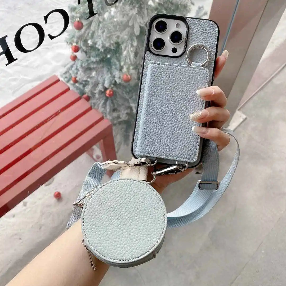 Phone case with detachable strap held by a hand, with blurred background