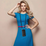 Woman in a blue dress with a black bag against a beige background